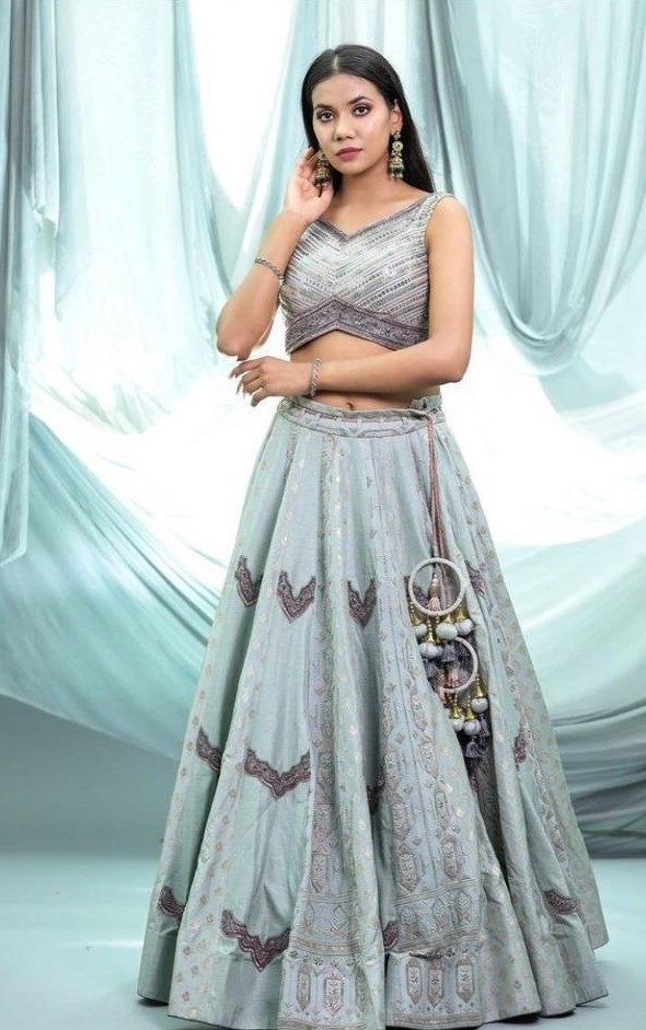 The sage green color lehnga and blouse comes with geometric sequins and khichdi pattern over lehnga